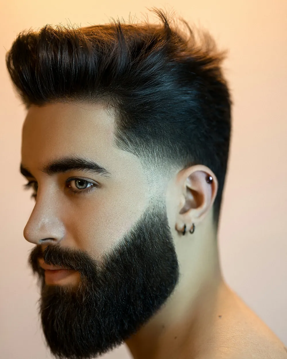 Portrait of a client with a swept-back cut and a full, shaped beard